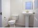 Bathroom featuring pedestal sink, toilet, and modern fixtures at 832 Gallery Course Dr, Las Vegas, NV 89148