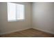 Bedroom featuring neutral carpet, white walls, and window with mini blinds at 832 Gallery Course Dr, Las Vegas, NV 89148