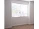 Bedroom featuring white walls, neutral carpet and large window at 832 Gallery Course Dr, Las Vegas, NV 89148
