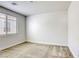 Neutral bedroom with a window, carpet flooring, and base trim at 832 Gallery Course Dr, Las Vegas, NV 89148