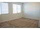 Bedroom with neutral carpet, window with blinds, white walls and trim at 832 Gallery Course Dr, Las Vegas, NV 89148