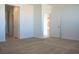 Spacious bedroom with neutral carpet, and white walls and trim, with open doors at 832 Gallery Course Dr, Las Vegas, NV 89148