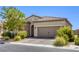 Lovely single-story home featuring desert landscaping, stone accents, and a two-car garage at 832 Gallery Course Dr, Las Vegas, NV 89148