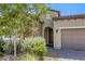 Charming home with stone accents, desert landscaping, and a two-car garage at 832 Gallery Course Dr, Las Vegas, NV 89148