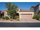 Charming single-story home with a well-maintained front yard, desert landscaping and a two-car garage at 832 Gallery Course Dr, Las Vegas, NV 89148