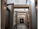 An interior hallway features modern lighting fixtures, paneled walls, and high ceilings, creating a bright and stylish passage at 832 Gallery Course Dr, Las Vegas, NV 89148