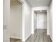 Bright hallway featuring contemporary flooring, white walls, and a view of the entrance door at 832 Gallery Course Dr, Las Vegas, NV 89148
