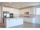 Well-lit kitchen with white cabinets, stainless steel appliances, a kitchen island, and granite countertops at 832 Gallery Course Dr, Las Vegas, NV 89148