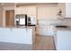 Modern kitchen featuring stainless steel appliances, white cabinetry, granite counters, and a breakfast bar at 832 Gallery Course Dr, Las Vegas, NV 89148