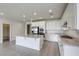 A kitchen with an island, white cabinets, granite countertops, and stainless steel appliances at 832 Gallery Course Dr, Las Vegas, NV 89148