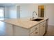 Kitchen island featuring granite countertop, stainless steel faucet, and cabinets facing into adjacent living space at 832 Gallery Course Dr, Las Vegas, NV 89148