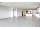 Open living room view showcases bright kitchen with stainless appliances, and tile floors for seamless flow at 832 Gallery Course Dr, Las Vegas, NV 89148