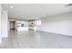 Expansive living room with bright kitchen featuring white cabinets and stainless steel appliances at 832 Gallery Course Dr, Las Vegas, NV 89148