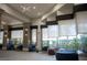 A lounge area displays cozy blue seating, large windows offering natural light, and stylish decor for a modern aesthetic at 832 Gallery Course Dr, Las Vegas, NV 89148