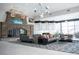 A grand lounge exhibits a stone fireplace, contemporary seating, and large windows, creating an inviting and sophisticated atmosphere at 832 Gallery Course Dr, Las Vegas, NV 89148