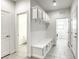 This mudroom has coat hooks, a built-in bench with drawers, and light gray wood-look tile flooring at 832 Gallery Course Dr, Las Vegas, NV 89148