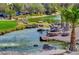 Scenic pond with rock accents, lush greenery, palm trees, and serene water at 832 Gallery Course Dr, Las Vegas, NV 89148