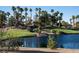 Picturesque pond on the golf course with a rock waterfall and lush landscaping at 832 Gallery Course Dr, Las Vegas, NV 89148