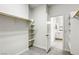 Walk-in closet with shelves, rod and access to bathroom with vanity and mirror at 832 Gallery Course Dr, Las Vegas, NV 89148