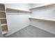 Spacious walk-in closet with custom shelving and gray plank flooring at 832 Gallery Course Dr, Las Vegas, NV 89148