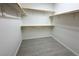 Walk-in closet with custom shelves and wood-look tile flooring at 832 Gallery Course Dr, Las Vegas, NV 89148