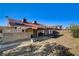 Wide view of a backyard featuring a patio cover, brick wall, and minimal landscaping at 8517 Soneto Ln, Las Vegas, NV 89117