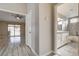 Hallway view into a bright bathroom featuring granite countertops and a shower-tub combo with modern fixtures at 8517 Soneto Ln, Las Vegas, NV 89117
