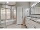 Modern bathroom featuring double vanity sinks, tiled shower, and a soaking tub with natural light at 8517 Soneto Ln, Las Vegas, NV 89117