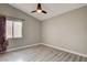 This bedroom features a vaulted ceiling, ceiling fan and light wood-look floors at 8517 Soneto Ln, Las Vegas, NV 89117