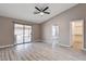 Bedroom with wood-look floors, access to the backyard, and a view into the attached bathroom and closet at 8517 Soneto Ln, Las Vegas, NV 89117