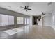 Open-concept living room with tile flooring and natural light, seamlessly connected to the kitchen at 9004 Snowtrack Ave, Las Vegas, NV 89149