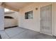 Covered patio with a security door and neutral colors, offering a private outdoor space at 9004 Snowtrack Ave, Las Vegas, NV 89149