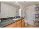 Bathroom with granite countertop vanity, tiled shower with tub, and wood-look flooring at 9130 Beauchamp Ave, Las Vegas, NV 89148