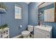 Stylish half bathroom featuring blue walls, updated fixtures, and modern decor at 9130 Beauchamp Ave, Las Vegas, NV 89148