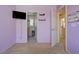 Lilac bedroom boasts a walk-in closet, mounted TV, and calming, coordinated decor at 9130 Beauchamp Ave, Las Vegas, NV 89148