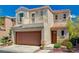Two-story home showcasing a two-car garage, balcony, arched front door, and low maintenance landscaping at 9130 Beauchamp Ave, Las Vegas, NV 89148