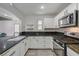 Bright kitchen with granite countertops, stainless steel appliances, and sleek white cabinetry at 9130 Beauchamp Ave, Las Vegas, NV 89148