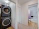 Convenient hallway features a stackable washer and dryer setup near a bathroom entrance at 9130 Beauchamp Ave, Las Vegas, NV 89148
