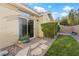 Charming backyard with stepping stones, manicured lawn, and desert landscaping for low maintenance at 9256 Blue Flax Pl, Las Vegas, NV 89148