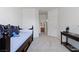 Neutral bedroom with a stylish daybed and a view through to the bathroom at 9256 Blue Flax Pl, Las Vegas, NV 89148