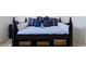 Comfortable daybed with stylish blue pillows and storage baskets underneath at 9256 Blue Flax Pl, Las Vegas, NV 89148