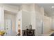 Hallway with table and chair, leading to bathroom and bedroom doors at 9256 Blue Flax Pl, Las Vegas, NV 89148