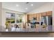 Bright kitchen featuring stainless steel appliances, wood cabinets, and a cozy breakfast nook at 9256 Blue Flax Pl, Las Vegas, NV 89148