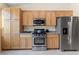 Charming kitchen with stainless steel appliances, wood cabinets, and ample counter space at 9256 Blue Flax Pl, Las Vegas, NV 89148
