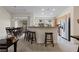 Open-concept kitchen features bar seating, stainless steel appliances, and lots of natural light at 9256 Blue Flax Pl, Las Vegas, NV 89148