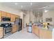 Bright kitchen features stainless steel appliances, a kitchen island, and light wood cabinets at 9256 Blue Flax Pl, Las Vegas, NV 89148