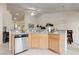 Well-lit kitchen with stainless steel appliances, breakfast bar, and tile flooring at 9256 Blue Flax Pl, Las Vegas, NV 89148
