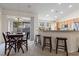 Bright eat-in kitchen with bar seating, stainless steel appliances, and a dining area at 9256 Blue Flax Pl, Las Vegas, NV 89148