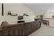 Spacious living room with a large sectional sofa and an open layout to dining room at 9256 Blue Flax Pl, Las Vegas, NV 89148