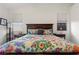 Cozy main bedroom featuring a decorative comforter, side tables, and bright natural light at 9256 Blue Flax Pl, Las Vegas, NV 89148